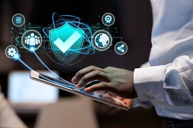professional using a tablet with cybersecurity icons representing digital security, compliance, and data protection.